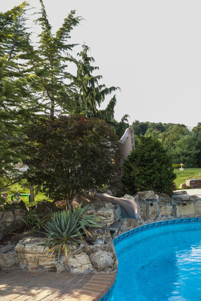 landscaping around pool with rocks